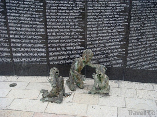 Smaller sculpture with memorial wall.