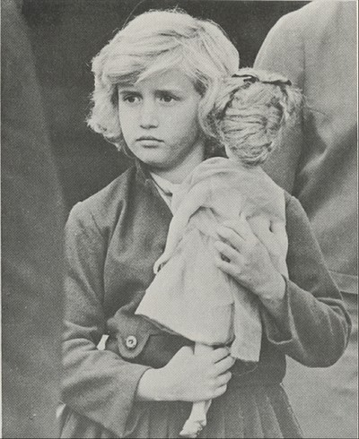 A young girl holds her doll as she arrives in the United States with the Operation Pedro Pan Program, circa 1960-1962. 