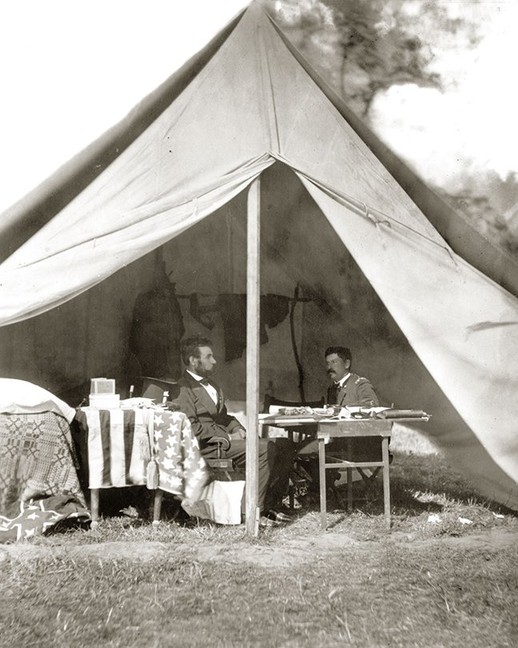 President Lincoln visited General McClellan at his camp headquarters on October 4, 1862. A close look at this photograph shows both the American flag and captured Confederate battle flag on the left.