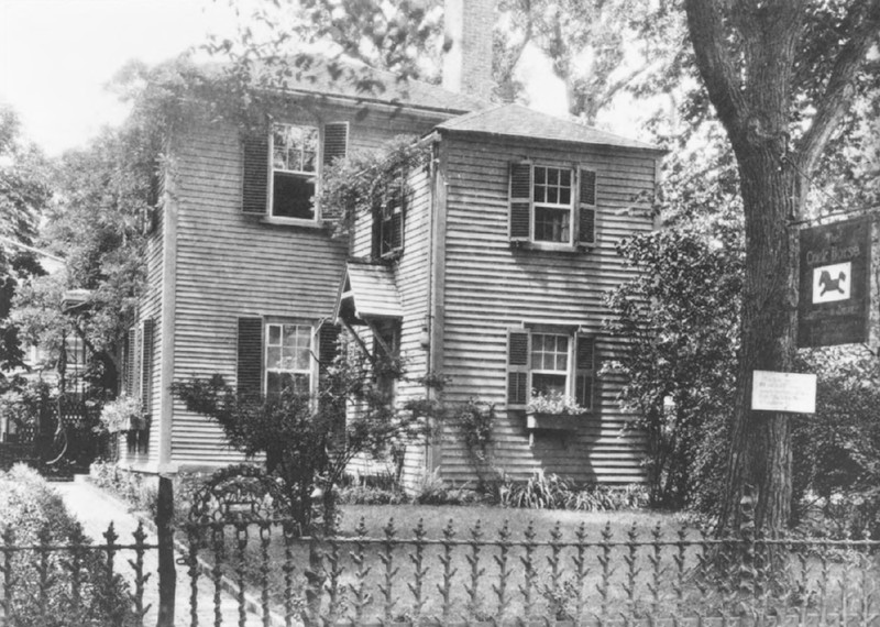 Black and white photo of a wood-panelled house