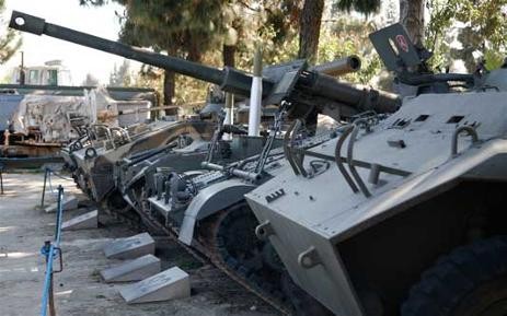 The museum features rows of static displays of military hardware. 