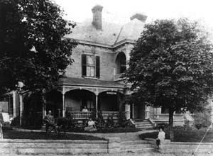 Old Kentucky Home/Thomas Wolfe Memorial in 1906. Thomas Wolfe as a child is siting on stone wall