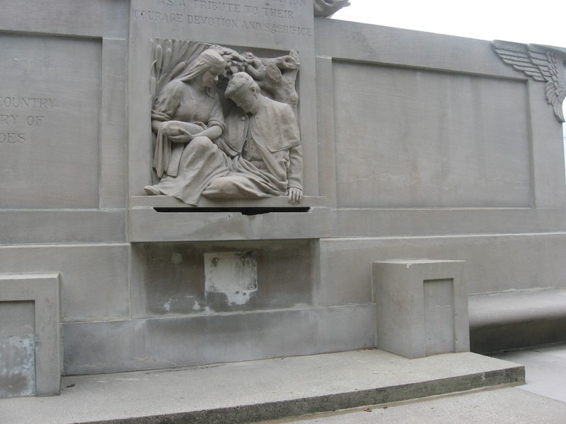 The relief on the back with the statue of the nurse treating a wounded soldier.