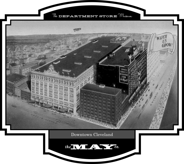 An aerial view, taken prior to 1931, when the main store building was raised from 6 to 8 stories, shows the large, T-shaped complex with storefronts on Euclid Avenue, Ontario Street, and Prospect Avenue to the rear.