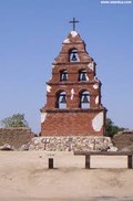 The original bell tower, on the road just outside of the mission. Called a "campanario," the bell tower was an essential part of mission achitecture.