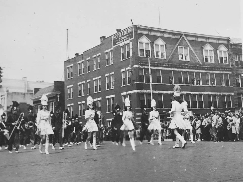 A band marches past the Hotel Adelphia