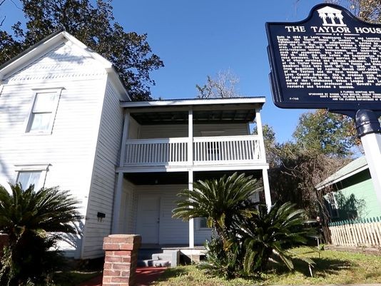 The Taylor House and the plaque that recognizes this a a site listed on the National Register of Historic Places