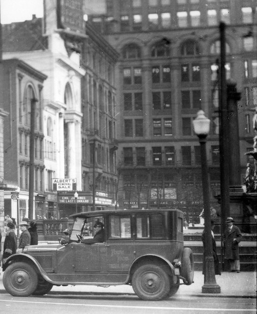 This is an early scene of downtown Cincinnati. If you look closely you can see the fountain in the background. 