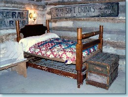 This is a picture of bedroom furnishings in the Pioneer Log Cabin located in Monroe Community Park.