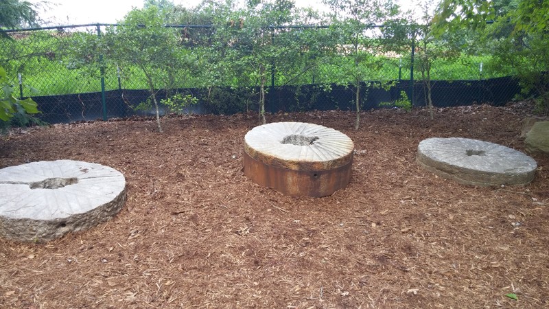 An assortment of millstones once used at Yates Mill.