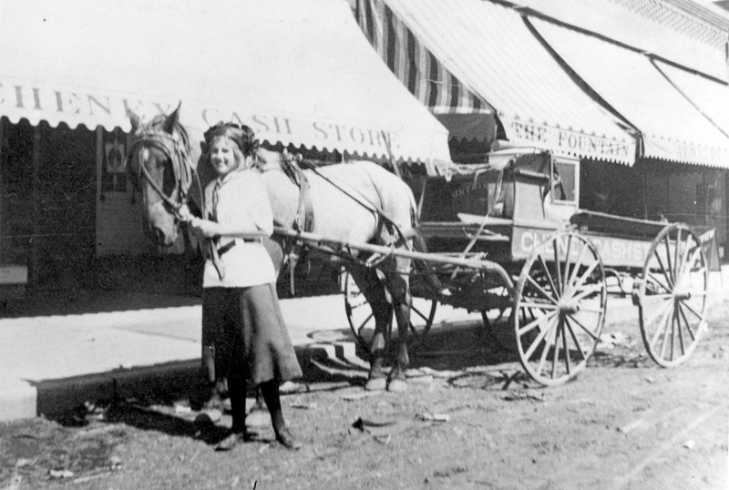 Girl with horse and wagon on street in front of The Fountain