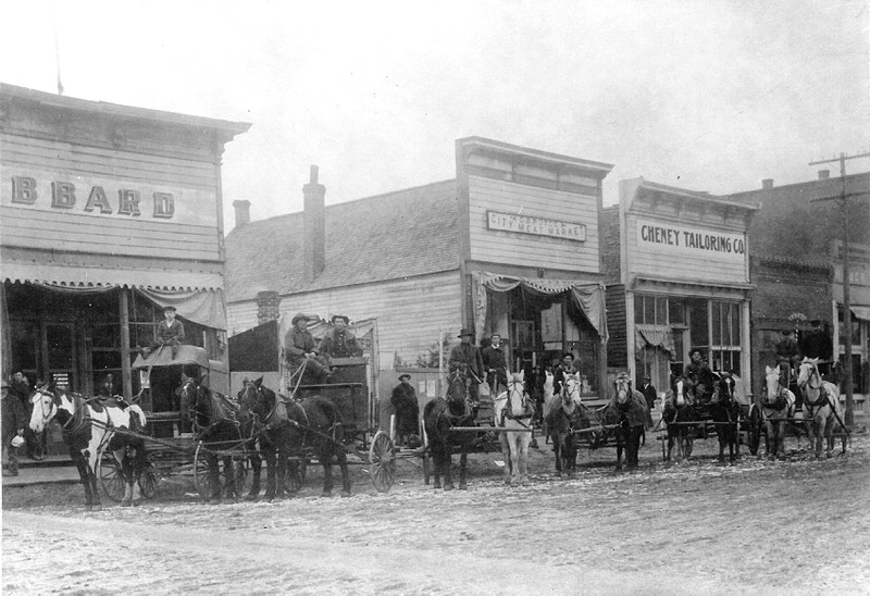 horses, wagons, drivers, in front of Royce's City Meat Market