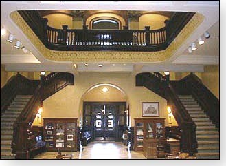 Here is  a view of the stunning view of the interior. There are double open stairways from the second floor to the third floor of the courthouse. There is a  cut-out ceiling exposing the top floor of the building.