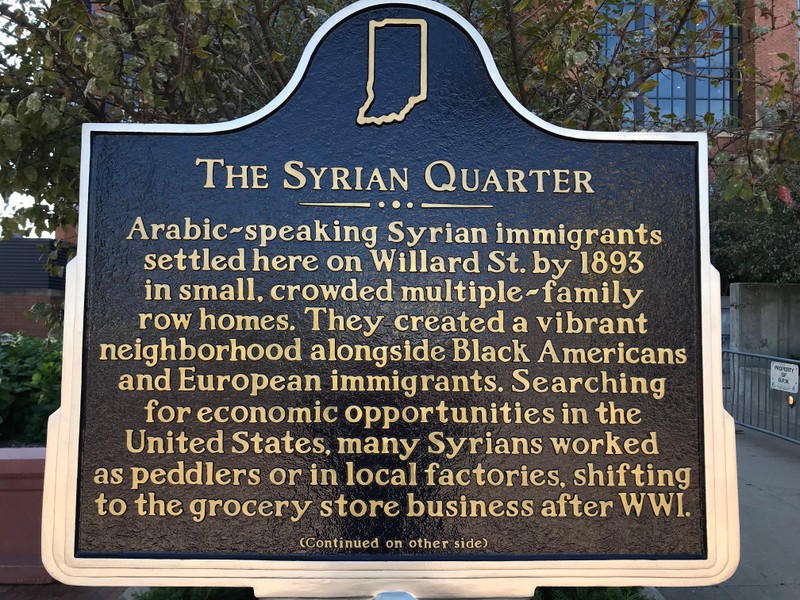 Arabic-speaking Syrian immigrants settled here on Willard St. by 1893 in small, crowded multiple-family row homes. They created a vibrant neighborhood alongside Black Americans and European immigrants. Searching for economic opportunity in the United States, many Syrians worked as peddlers or in local factories, shifting to the grocery store business after WWI. 