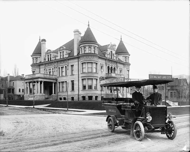Kearns Mansion shortly after it was constructed. Photo includes vehicle used for bus tours of Salt Lake City in the early 20th century.