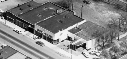 aerial view of gas station and car dealership