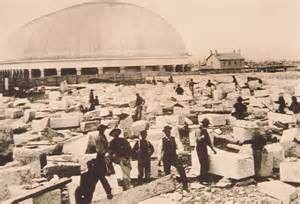 1870-1880s photo of men continuing to work on the Salt Lake City temple. The newly finished tabernacle sites in background