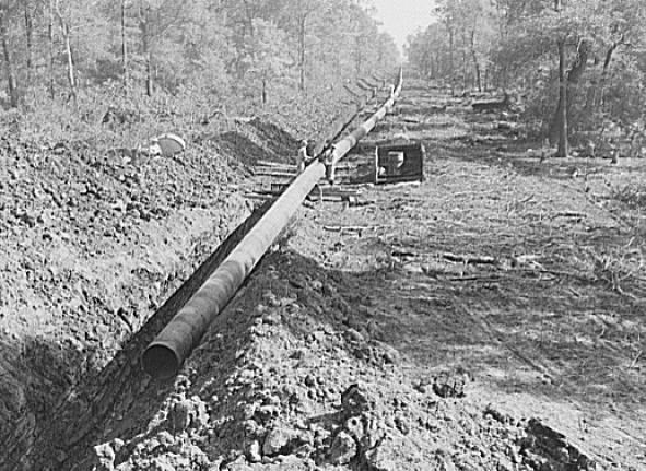 "Big Inch pipeline running through wooded land" by Vachon, John, 1914-1975. 