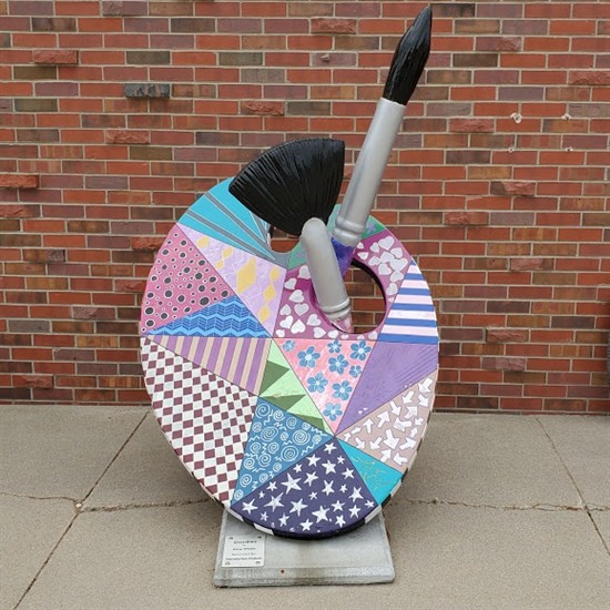 Painted by Amy Webb Located in front of the Cozad City Offices Amy Webb is a graphic design artist with an Associates of Applied Science degree in Visual publications from Southeast Community College-Lincoln. She is currently living and working in North Platte. She has been employed by Coors Distributing for 8 years and is engaged to be married in October of 2019. The inspiration behind her abstract design was zentangle patterns. Zentagle art is an American drawing method developed in 2005 that promotes creativity and concentration as well as inner wellbeing. It is a combination of art and meditation.
