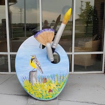 Painted by Bobbi Laird Located at Meadowlark Pointe Bobbi Laird is a self-taught artist who hones her craft through the use of adult art education classes and seminars. She has dyslexia, making it very difficult to read and spell, but has found that having dyslexia has helped her in design, composition and color combination. Bobbi uses her art to share her faith stating, “it’s an ongoing process of internalizing God’s wonderful gift of creation”. She would like to thank Cozad for arranging the opportunity to share the talented folks of our city and is grateful for the support and love that Cozad has for the arts.