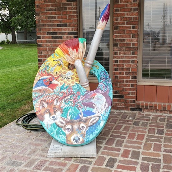 Painted by Sue Perez Located in front of McKeone Law Office Sue Perez is a self-taught artist who has endeavored to encapsulate the spirit and the strength of life experiences through her art. Her creative journey began about 19 years ago when a devastating tornado left her to ponder man’s time on earth and how her art could leave an impression on future generations. Her exploration into the aesthetic of the commonplace has resulted in a deep appreciation of the truth and beauty of everyday ordinary things. For Sue, art is a celebration of life. Her award-winning artwork has been included in several worldwide publications and graces the walls of admirers in all 50 states as well as 29 countries. Locally, a selection of her work is on display at the Prairie Arts Center in North Platte.