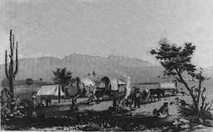 1857 of wagons stopping at Maricopa Wells, modern day Maricopa. Mountains in the background is where the battle was fought. 