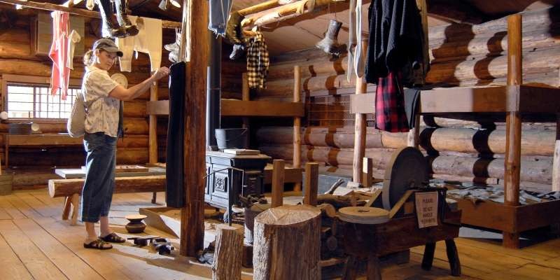 A visitor looks over some of the logging artifacts at the museum.