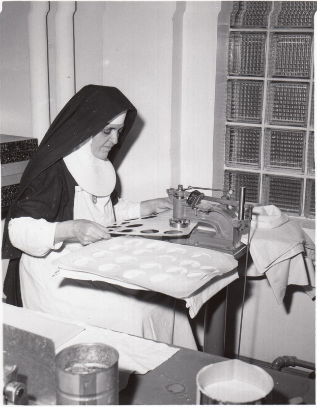 A nun making altar bread.