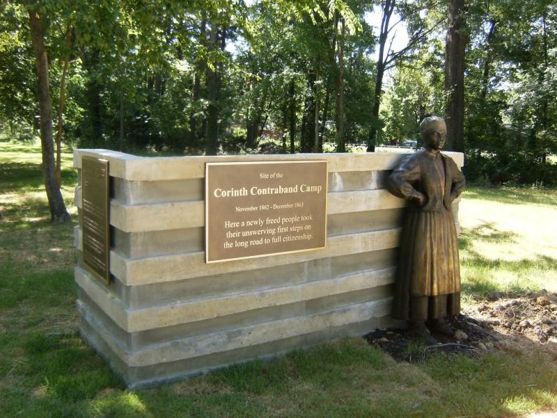 This statue depicting a woman leaning on the monument is one of several large statues at the historic camp.