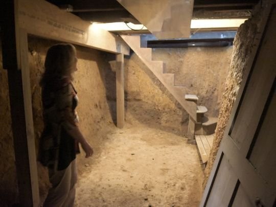 The basement space/root cellar located under the house's kitchen that was used to hide runaway slaves.  