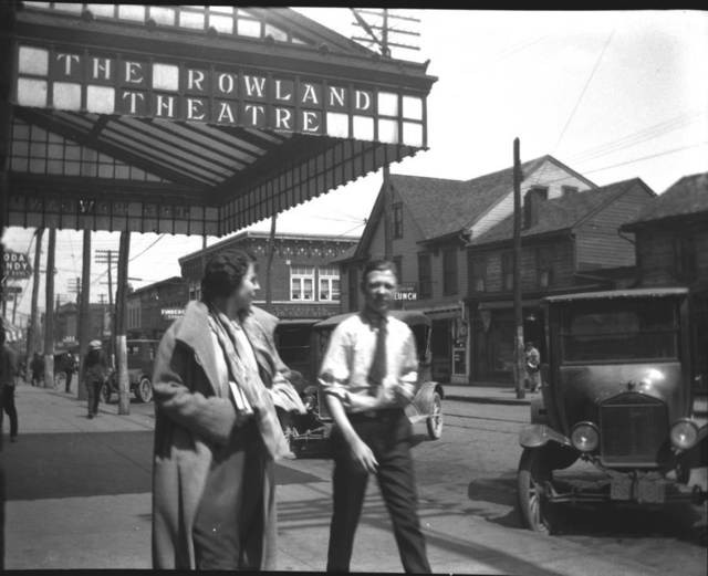 A couple leaves after a showing at the Rowland, 1920s-1930s