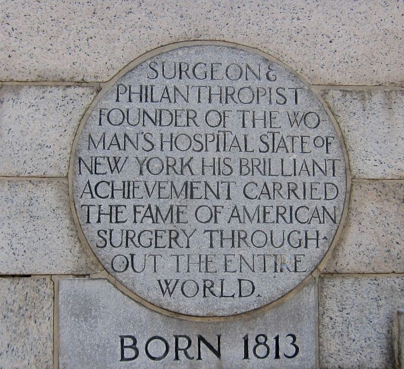 The first plaque on the statue that explains Sims's past fame as a physician.