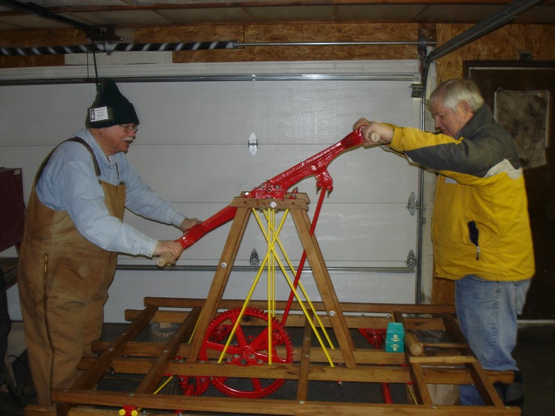 Lisle Heritage Society volunteers demonstrate the hand pumper