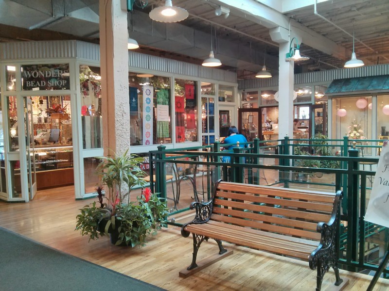 Interior common space with shops in the background.