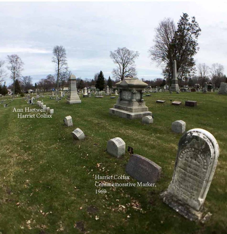 Several markers in a cemetery with labels describing three.