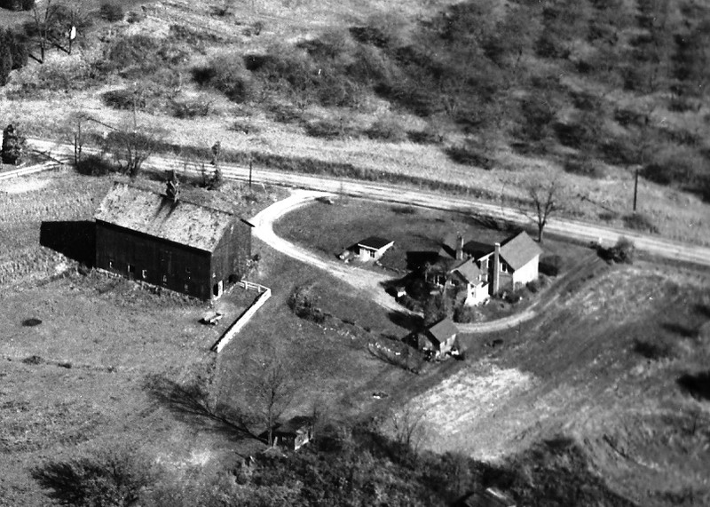 Aerial view of the farm circa 1956. Note the apple orchard across the road from the farm. The orchard was a part of Quick farm. 