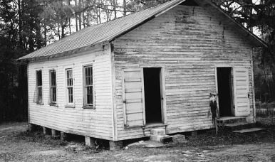 A Black and white photo of the front of the schoolhouse.