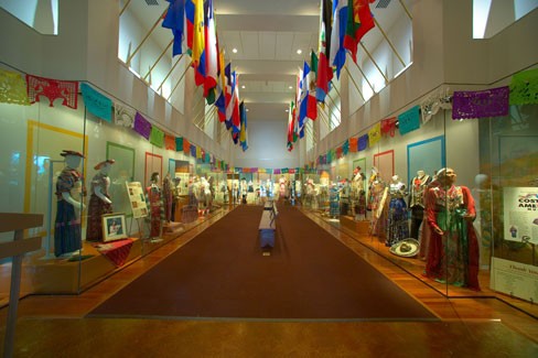 The entrance to the Costumes of the Americas Museum displays the flags of  the many nations represented by its vast collection of clothing, shoes, jewelry, and accessories.