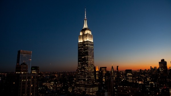 The top of the building lit up at night.