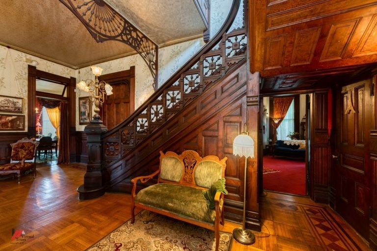 The interior features elaborate woodwork and antique furnishings.