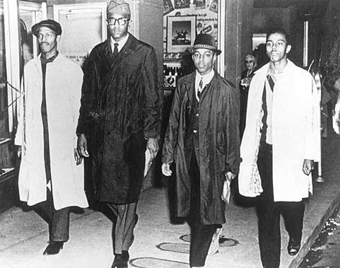 The A & T Four photographed outside of Woolworth following their first day of protesting segregation.