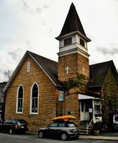 A view from across the street, showing off the churches original steeple.