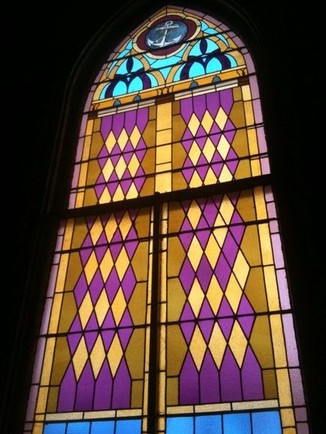 One of the many original stained glass pieces within the church.