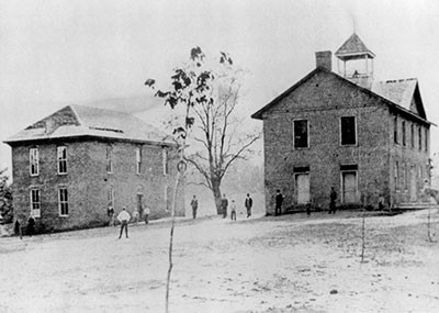 Founder’s Hall, on the left, is still used today.The building on the right was the first campus building (1856-1901). Photo courtesy of Southern Appalachian Archives. 