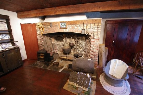 The kitchen features a large fireplace