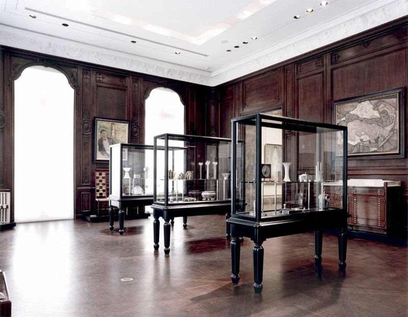 The dark wood paneling of the building is balanced out by plenty of natural light and white plaster ceilings. 