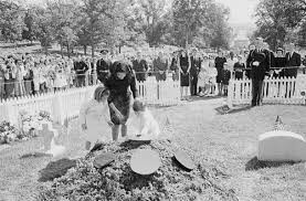 Mrs. Kennedy lighting the Eternal Flame.