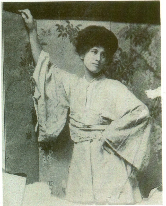 Black and white portrait of woman in Japanese dress in front of silk screen