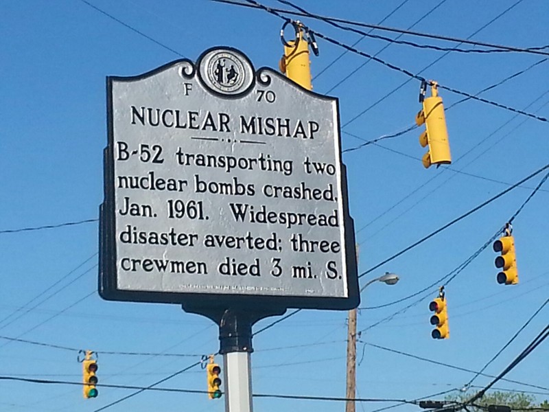 The historic marker is located in the center of town where more people might read it. The crash site is located three miles north of the sign.