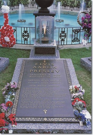 The grave of Elvis Presley located on the south side of the pool at Graceland. An eternal flame is lit at the head of Elvis' grave.